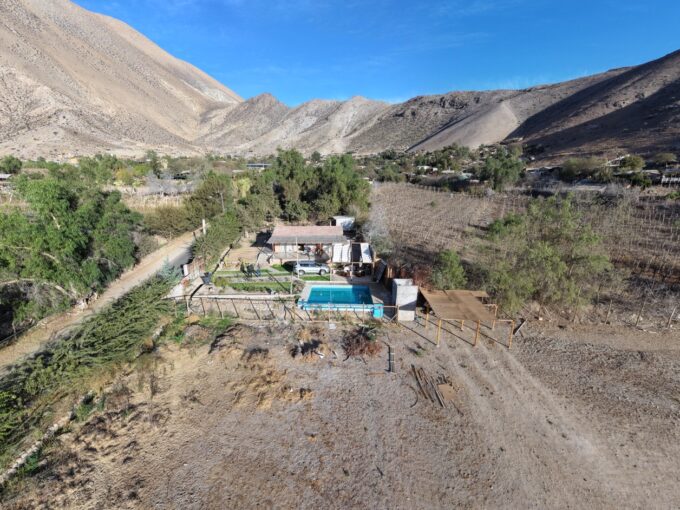 Vista aérea de una parcela con casa y piscina entre cerros en Peralillo, Valle de Elqui
